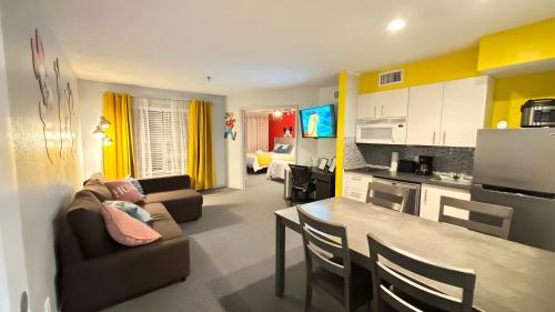 a kitchen and living room with a couch and a table at Whimsical Condo 1.5M from Disney in Orlando
