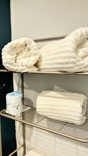 a towel rack with towels on it in a bathroom at Whimsical Condo 1.5M from Disney in Orlando