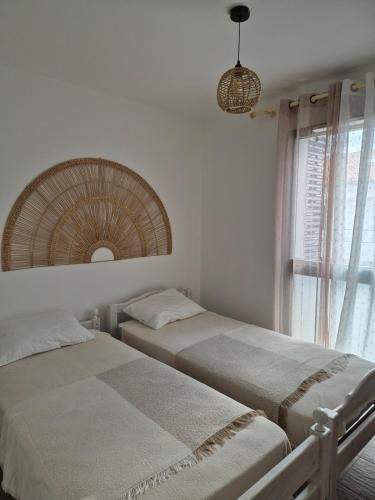 - 2 lits dans une chambre avec un miroir et une fenêtre dans l'établissement Appartement 4 pers en résidence, à Propriano