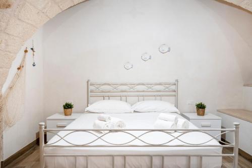 Ένα ή περισσότερα κρεβάτια σε δωμάτιο στο Casa Sardella, in pieno Centro Storico a 300 mt dal mare
