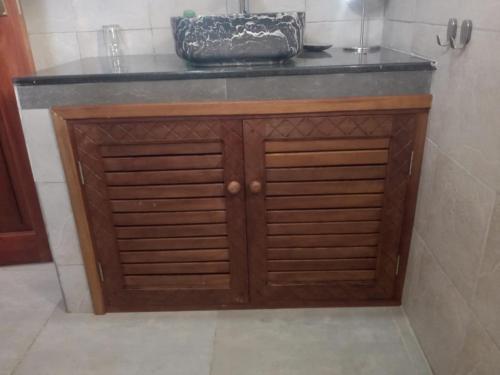 a wooden cabinet with a counter top in a bathroom at Vacation Villa Diani Beach in Kinondo