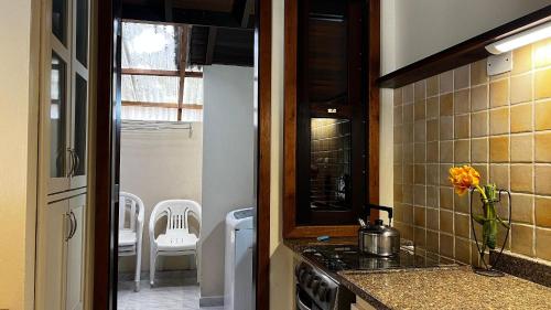 a kitchen with a sink and a stove top oven at Residencial Martins in Bombinhas