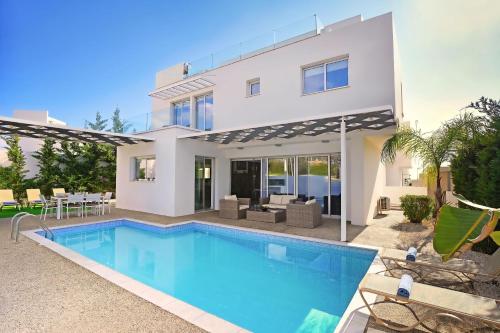 a villa with a swimming pool and a house at Villa Catalina in Ayia Napa