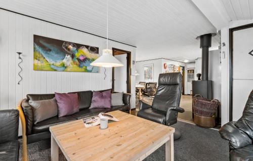 a living room with a couch and a table at Holiday Home Vester Kirketoft Fanø Ix in Fanø