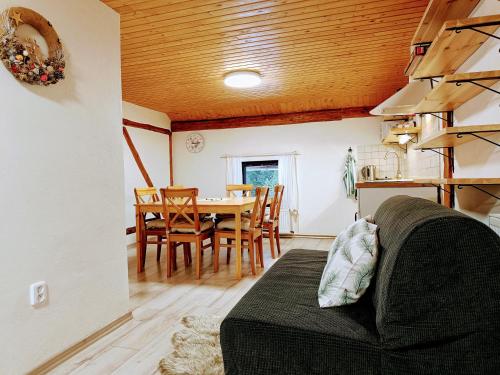 a living room with a couch and a table at Chalupa pod Klepáčem in Králíky