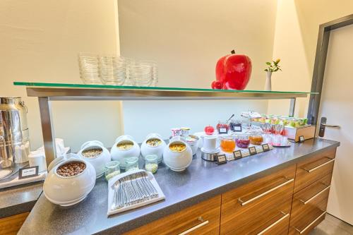 a buffet of food on a counter in a room at Hotel Apfelbaum in Erding