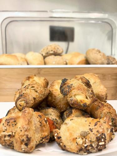 a pile of bagels sitting on top of a plate at Hotel Giotto in Padova