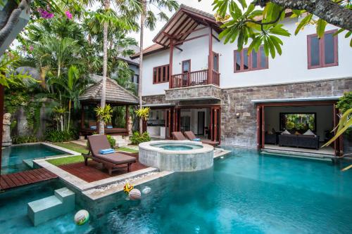 a swimming pool in the backyard of a villa at Villa Annecy in Seminyak