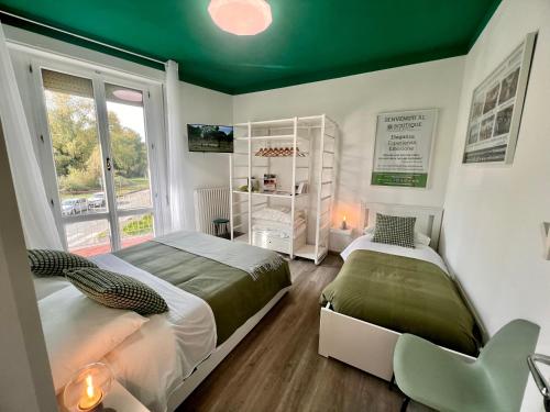 two beds in a room with a green ceiling at Boutique Apartment Natura in Chiusi