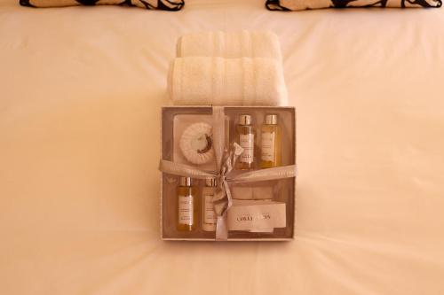 a box filled with bottles and towels on a bed at Tygerviews on Uys in Tygerberg Hills