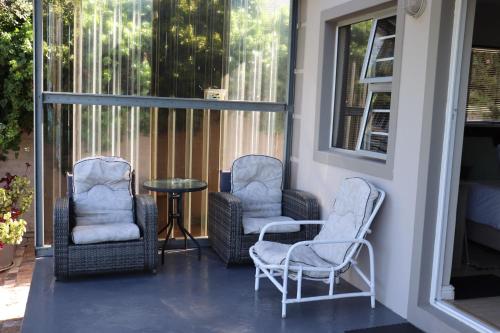 two chairs and a table on a porch at Tygerviews on Uys in Tygerberg Hills