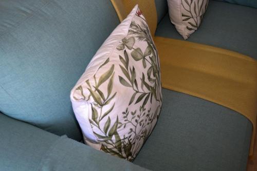 a pink pillow with a plant pattern on it at Tygerviews on Uys in Tygerberg Hills