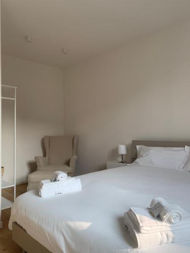 a bedroom with a large white bed with towels on it at Spazio Perlasca Apt 2 - Cernobbio Como Lake in Cernobbio