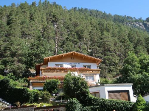 a house on a mountain with trees in the background at Holiday Home Palman by Interhome in Pfunds
