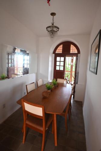 a dining room with a wooden table and chairs at Pousada Convento da Conceição in Olinda