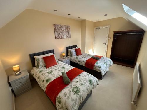 a bedroom with two beds and a tv in it at Dawn Chorus house, Ravensdale in Dundalk
