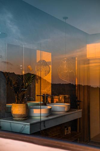 a bathroom with three sinks and a potted plant at Inn Harmony Villa Seaview in Ko Phangan