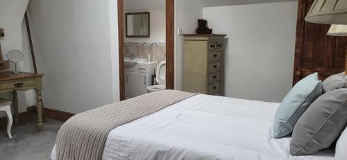 a bedroom with a bed and a bathroom with a sink at One Twenty B in Stockton-on-Tees