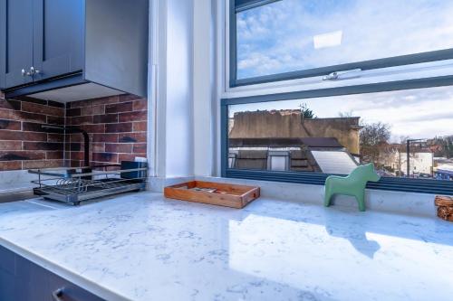 a kitchen with a large window and a stove at City View Flat, Quiet Bedroom, Work Ready Desk in Bristol