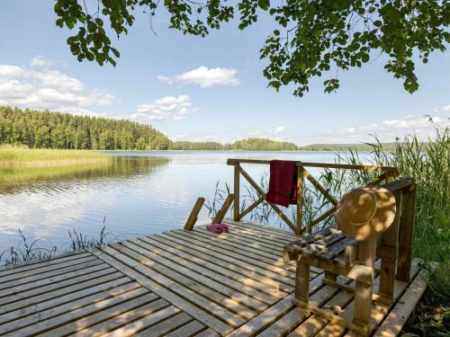 a bench on a dock next to a body of water at Holiday Home Rinnekämppä by Interhome in Pätiälä