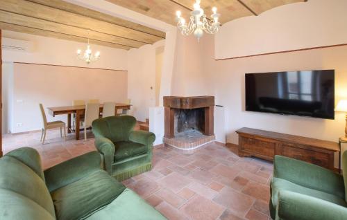 a living room with a couch and a tv and a fireplace at Stunning Home In Spello With Wifi in Spello