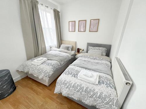 a bedroom with two beds and a window at Permazing in Southampton