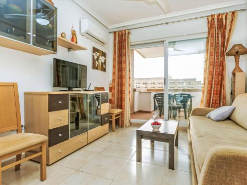 a living room with a couch and a tv at Apartment La Mar Bella by Interhome in El Borseral