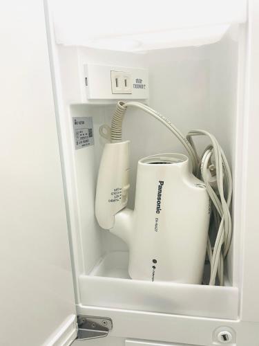 a refrigerator with two white appliances in it at Comfort Boutique Room in Tokyo