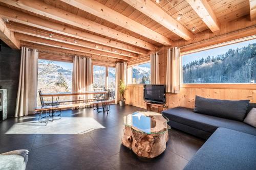 a living room with a couch and a table at Chalet Le Mas Devant in Morillon