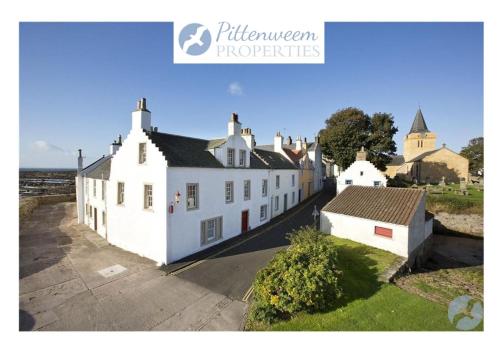 a group of white buildings on a street at Merchants House- stunning seaview period home in Anstruther