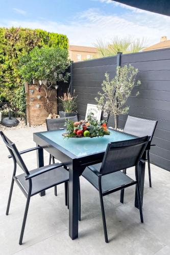 une table bleue avec deux chaises et un bol de légumes dans l'établissement Holiday Home Le Puit Michel by Interhome, au Lavandou