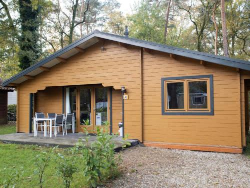 a tiny house with a porch and a patio at Holiday Home De Brenkberg by Interhome in Schinveld
