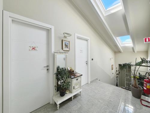 a hallway with a white door and a skylight at Pepe's Home B&B in Nichelino