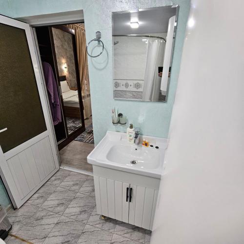 a bathroom with a white sink and a mirror at Hotel Jasmina in Samarkand