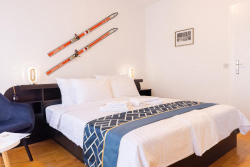 a bedroom with a bed with two skis on the wall at Retro house in Kamnik in Kamnik