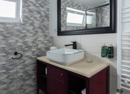 a bathroom with a white sink and a mirror at MAGISTER seven in Sibiu