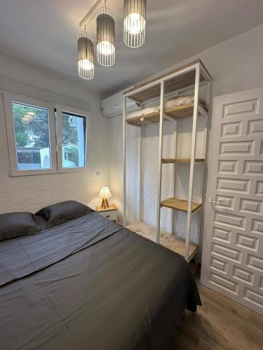 a bedroom with a bed and a book shelf and lights at Casa Luna Javea in El Tosalet