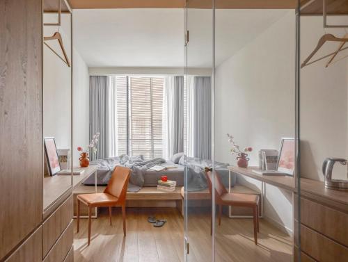 a living room with a glass table and chairs at Express by M Village Global City in Ho Chi Minh City