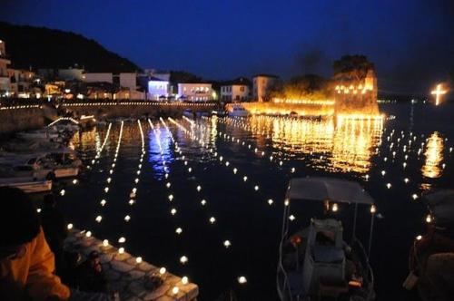 a marina with lights in the water at night at Helen's Seaside Apartment in Nafpaktos