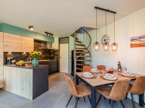 a kitchen and dining room with a table and chairs at Holiday Home Solipi by Interhome in Nieuwvliet-Bad