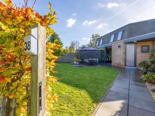 an external view of a house with a yard at Holiday Home Solipi by Interhome in Nieuwvliet-Bad