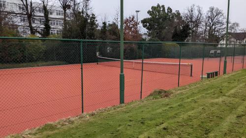 a tennis court with two tennis courts at Beckenham Beauty: Modern 1-Bedroom Abode in Beckenham