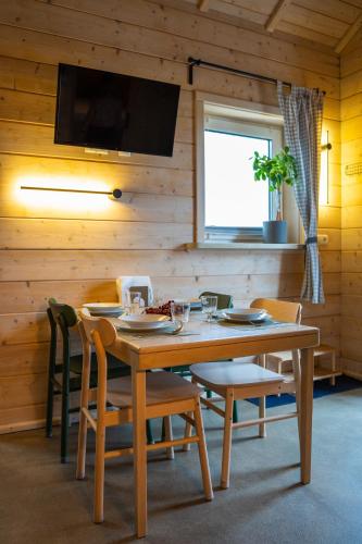 a wooden dining room with a table and chairs at Homemade Apartment in Liebshausen