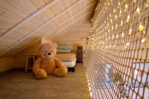 a teddy bear sitting on the floor of a room at Homemade Apartment in Liebshausen