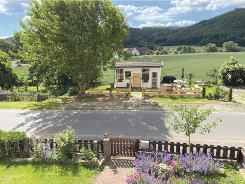 a house with a driveway and a fence at Landhaus Wahmbeck in Wahmbeck