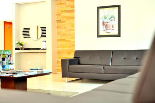 a living room with a couch and a coffee table at Hotel Executivo in Araguaína