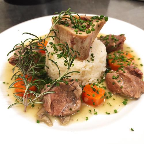 a plate of food with rice and meat and vegetables at Route 999 in Alzon