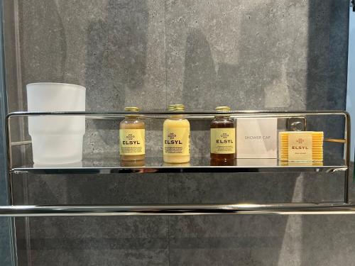 four bottles of essential oils sitting on a metal shelf at Lansdowne House with Private Car Park in Llandudno