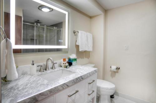 a bathroom with a sink and a toilet and a mirror at Tamarron Lodge Studio 343 in Durango