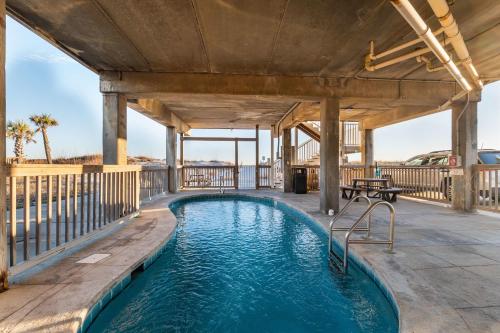 a swimming pool on the deck of a house at Beachfront - 2 Bedrooms - Big Screen TV in Gulf Shores